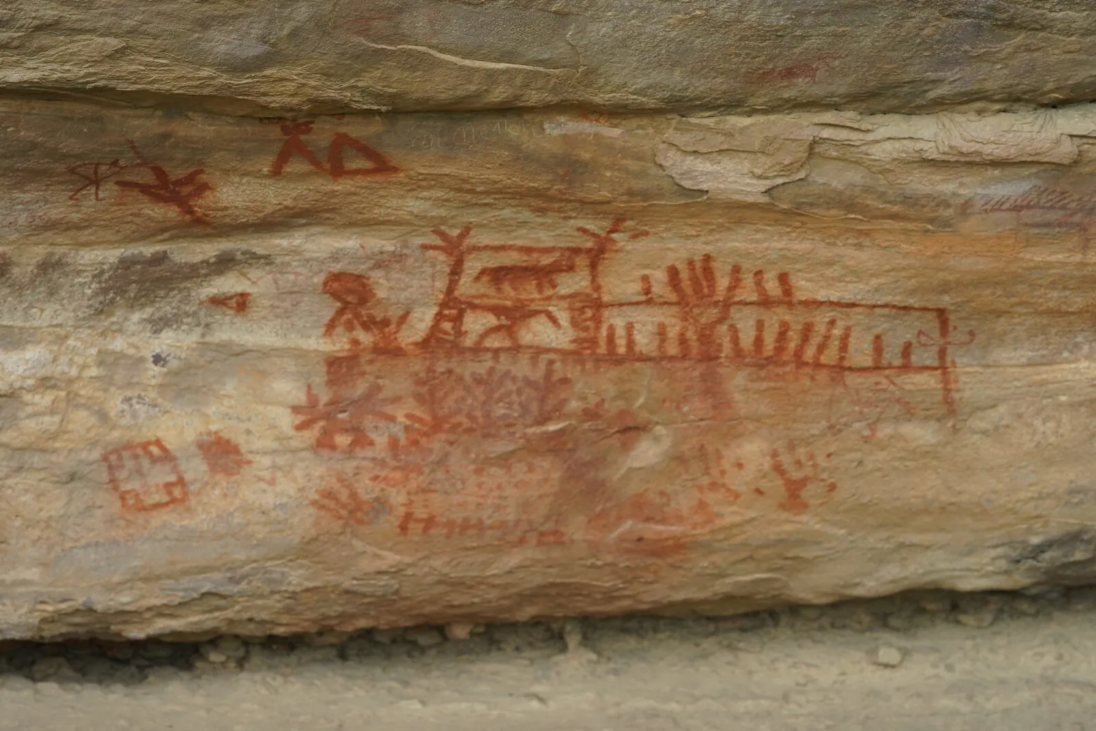 ochre figures on the shelter wall